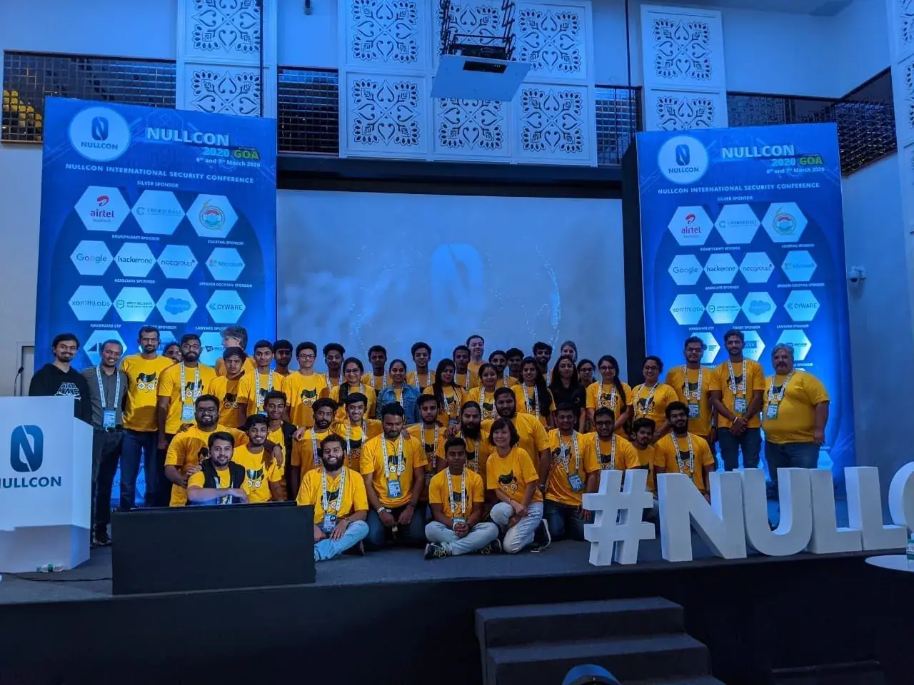 The Nullcon 2020 Con-troller team on stage in Goa, in yellow t-shirts