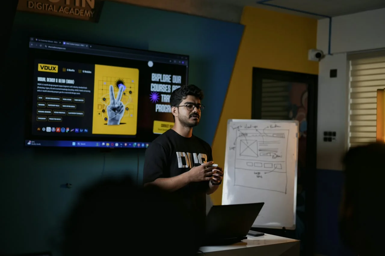 Me teaching a class at Dotin Digital Academy, with a wireframe sketch on the whiteboard