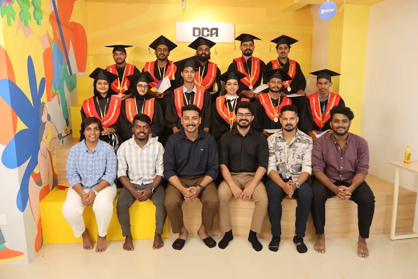 Graduation day at DCA: the graduates in caps and gowns with the team